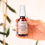 Hand holding Reviva Labs dark spot brightening serum