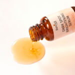 Amber bottle pouring brightening facial serum