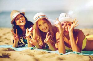 three young woman on beach