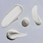 Smears of white cream on paper