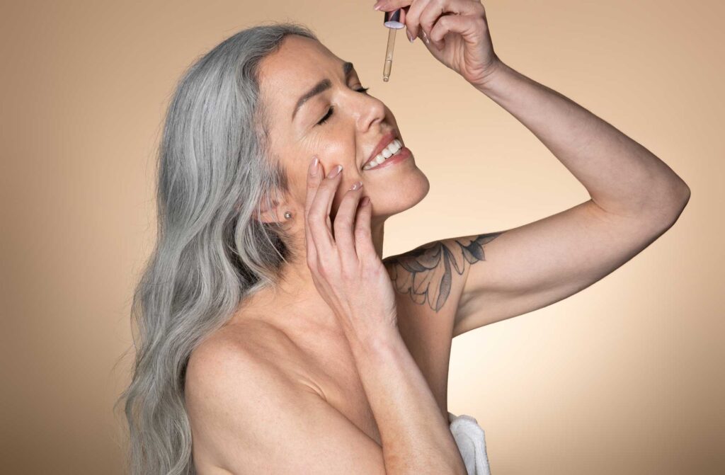 beautiful smiling senior woman applying facial ser 2025 03 18 16 29 16 utc