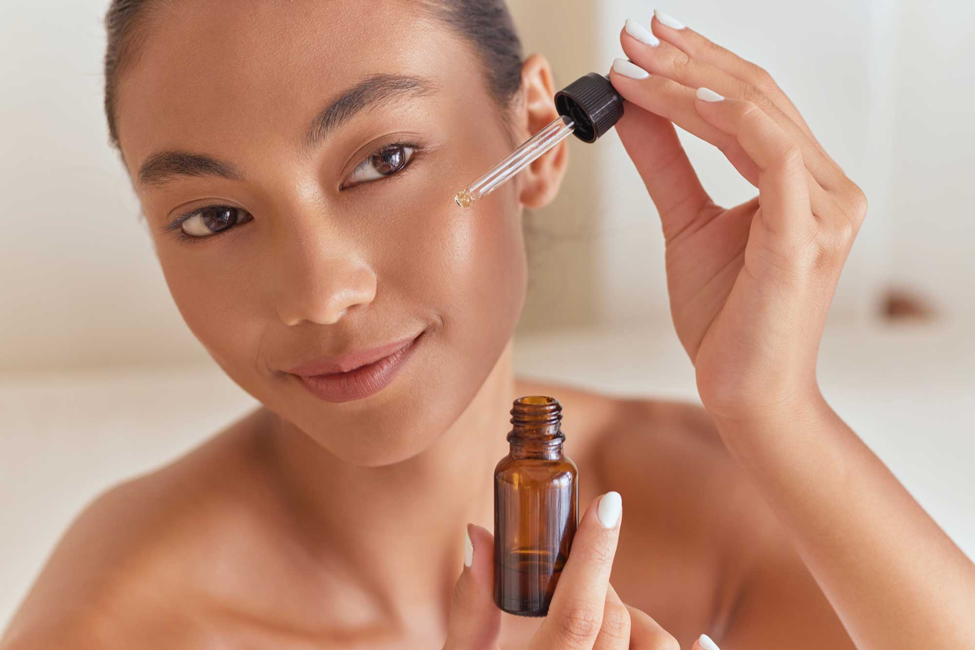 Woman applying a morning skincare routine for glowing healthy skin