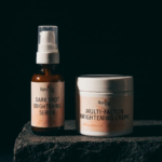 Brightening serum and cream on dark background