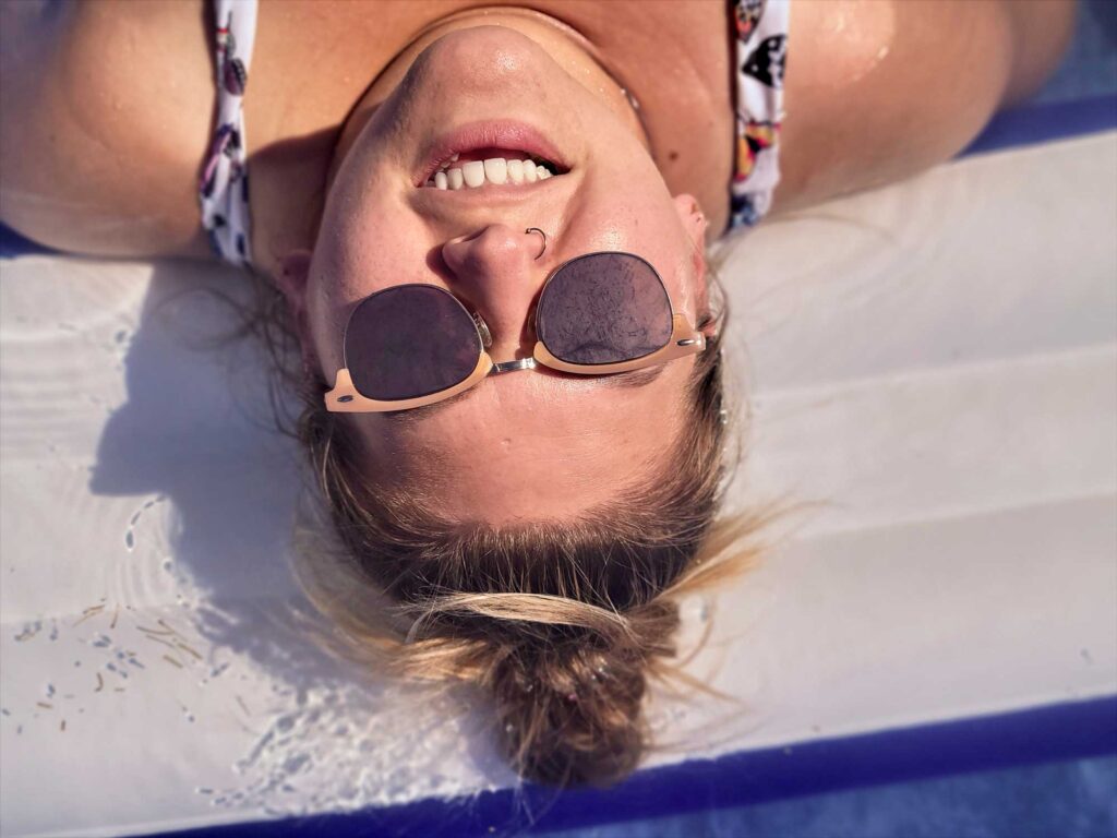 woman smiling upside down in an inflatable pool 2024 12 04 11 27 46 utc