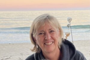 Smiling person at beach during sunset