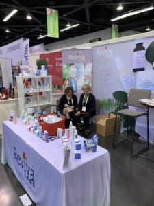 Skincare products displayed at a Reviva Labs booth.