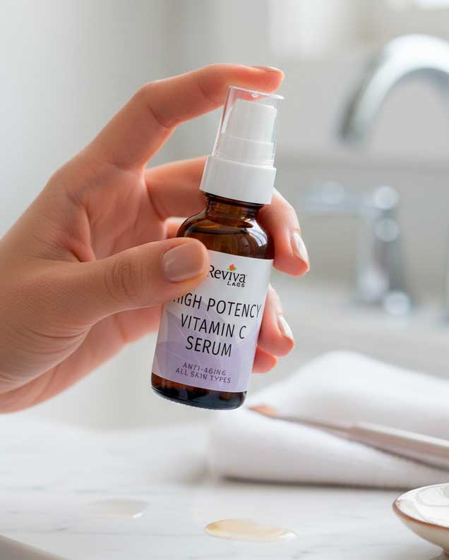 Hand holding vitamin C serum bottle