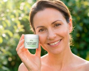 Woman holding night cream outdoors