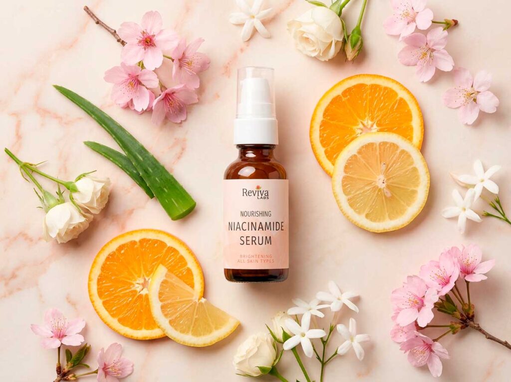 Niacinamide serum surrounded by flowers and citrus.