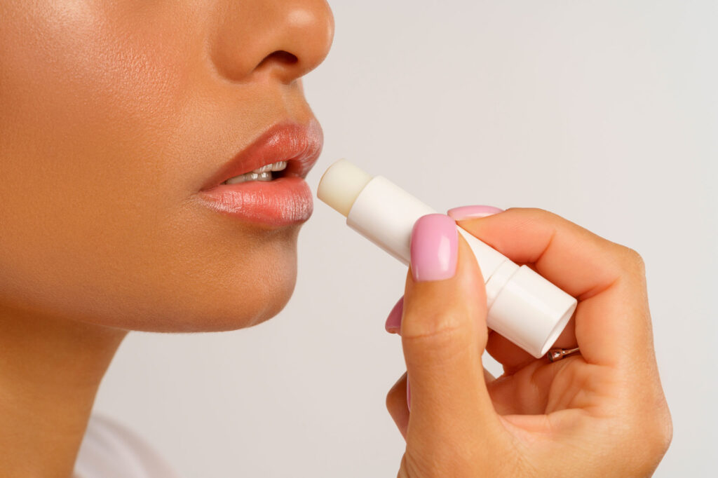 Close-up of person applying lip balm
