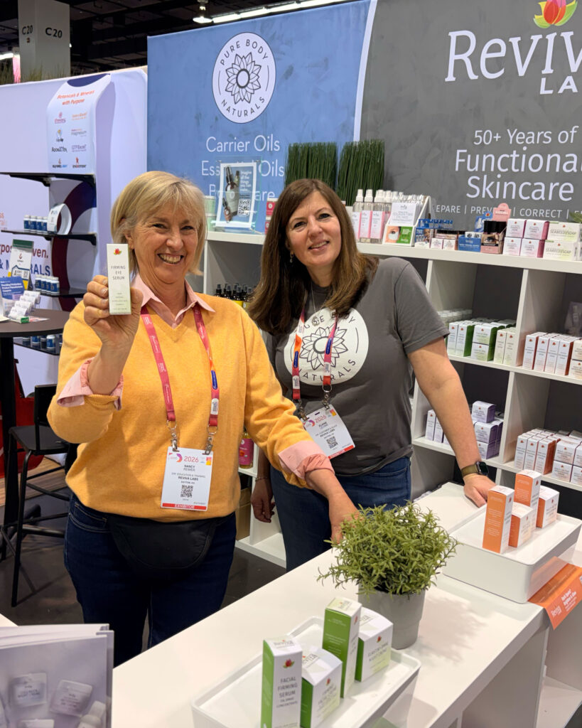Two women at a skincare booth display