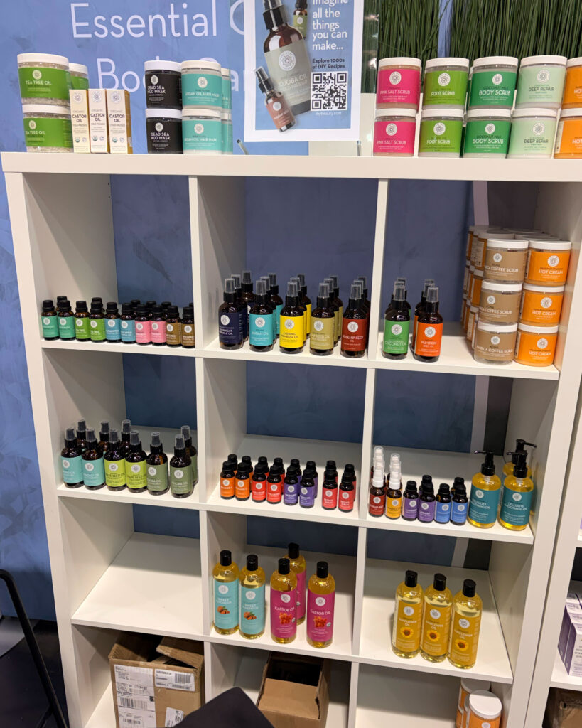Shelf displaying various essential oils and scrubs