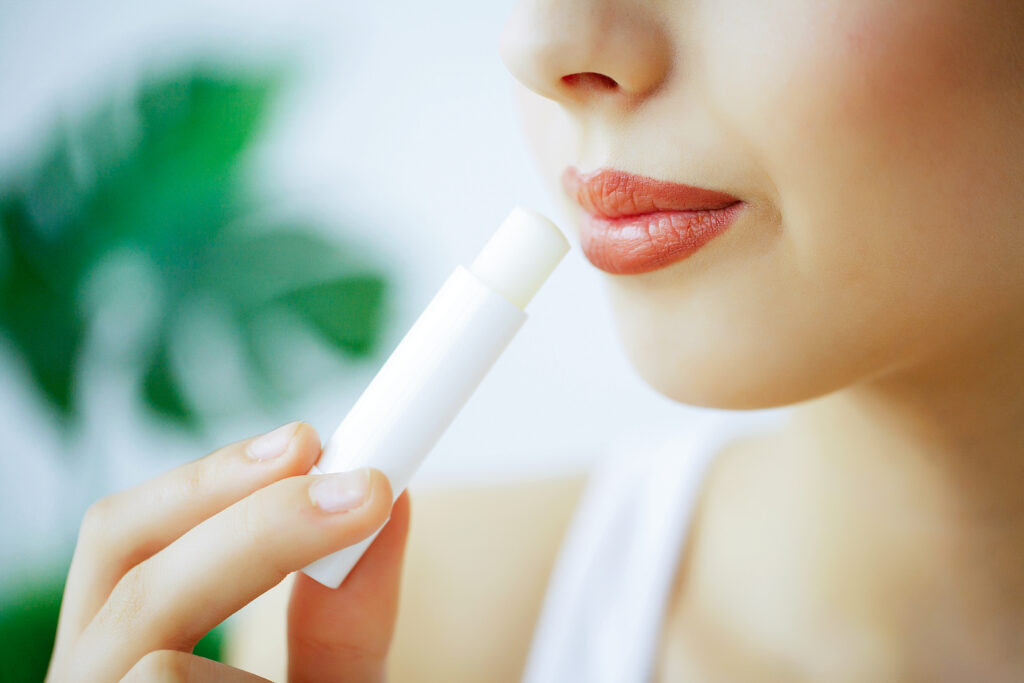 Close-up of person applying lip balm