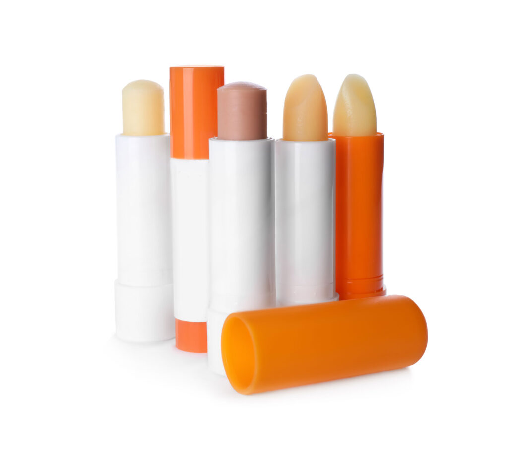 Variety of lip balm sticks displayed together.