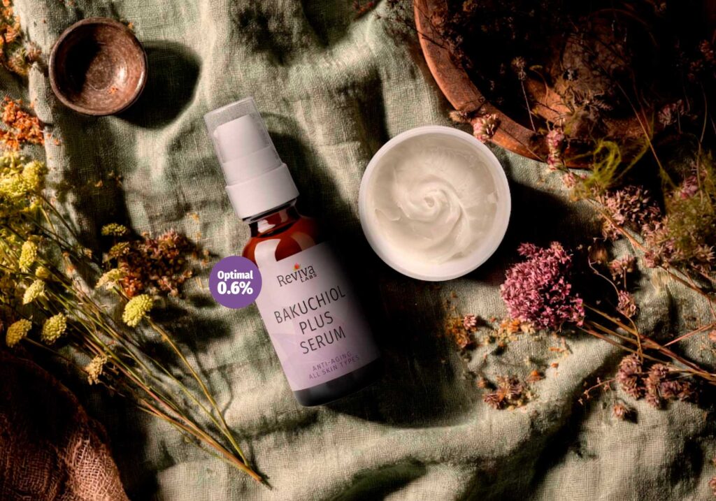 Bakuchiol serum bottle with cream and dried flowers