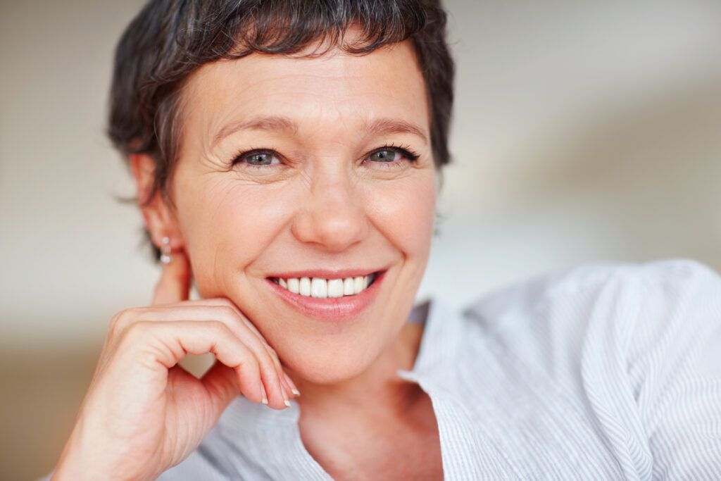 Smiling middle-aged woman close-up portrait indoors