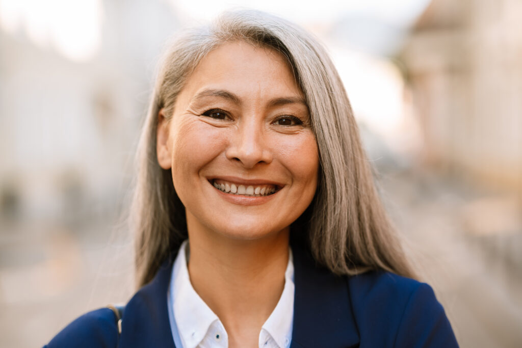 Smiling professional woman with gray hair outdoors