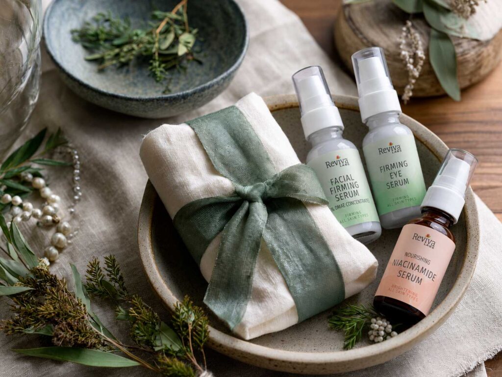 Skincare serums arranged with greenery and wrapped cloth