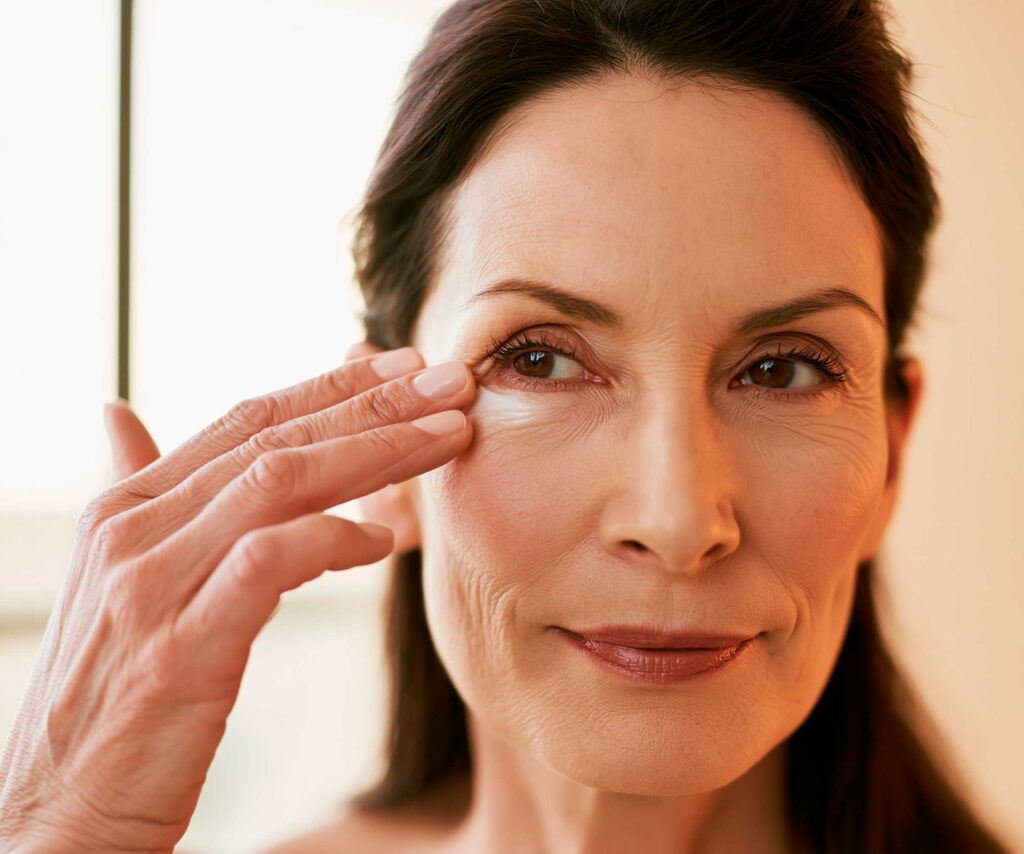 Woman applying skincare under her eye