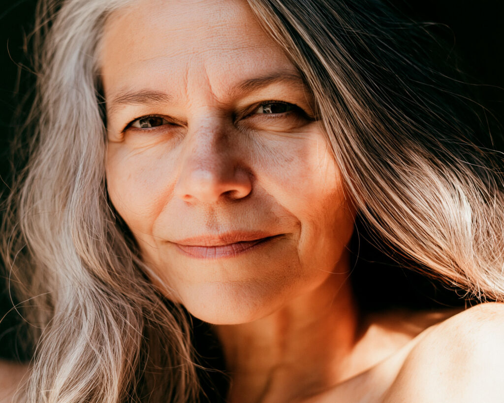 Close-up portrait of smiling gray-haired woman