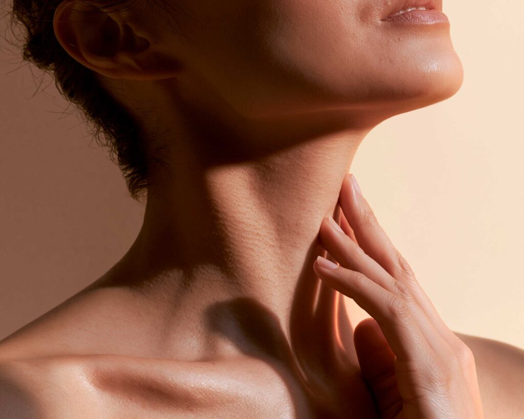 Close-up of woman touching her neck