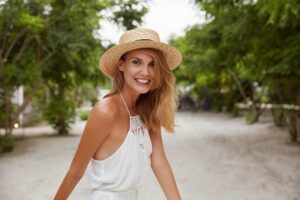 Smiling woman in straw hat outdoors