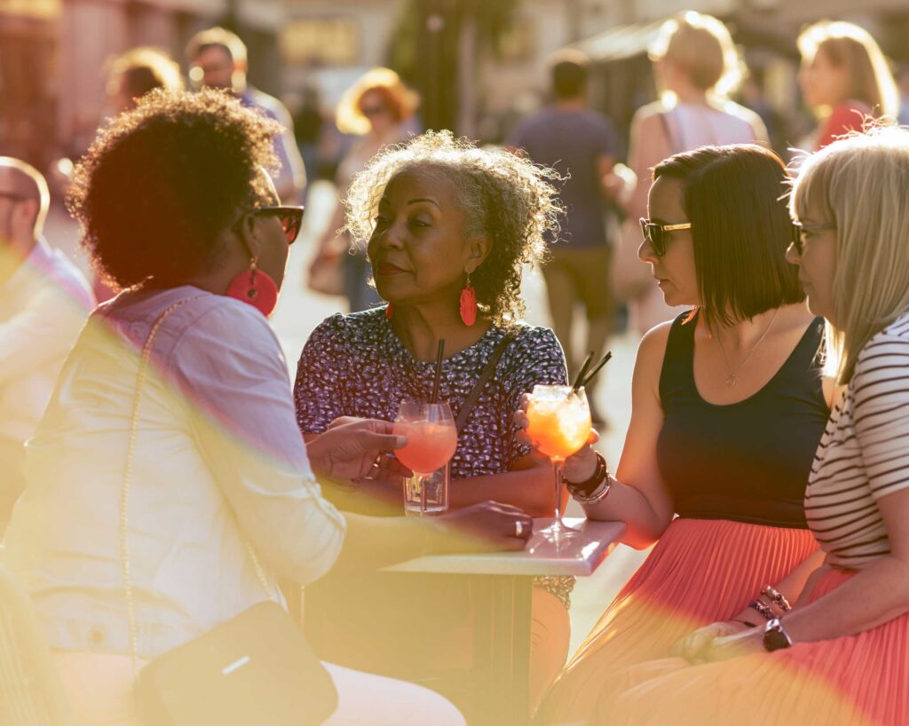 Women enjoying cocktails at outdoor cafe
