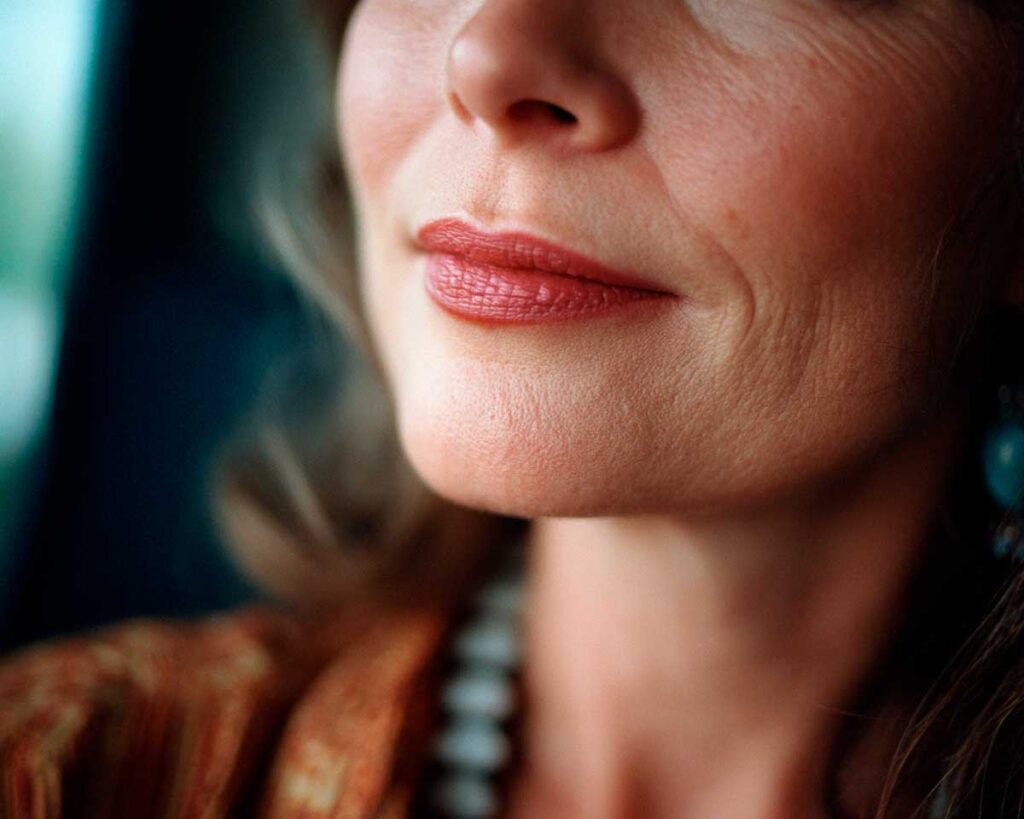 Close-up of woman's lips and chin with lipstick