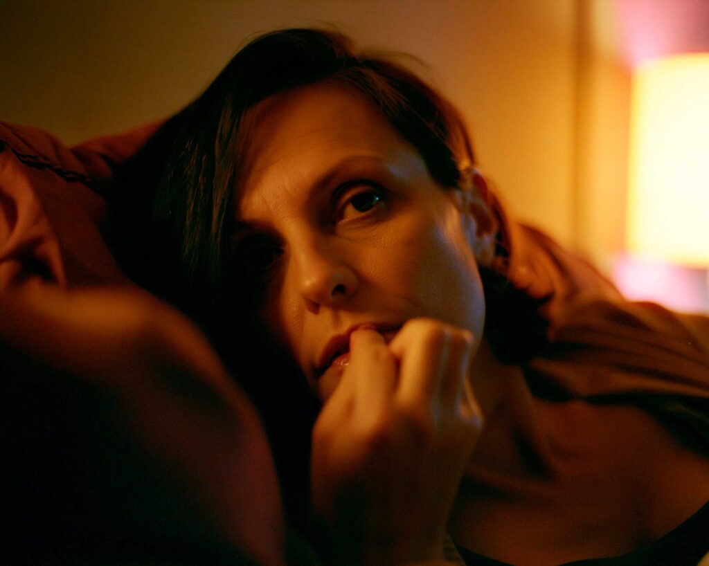 Woman resting in warm lamplight close-up portrait