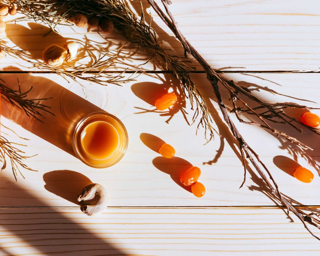 Honey jar with sea buckthorn berries and twigs