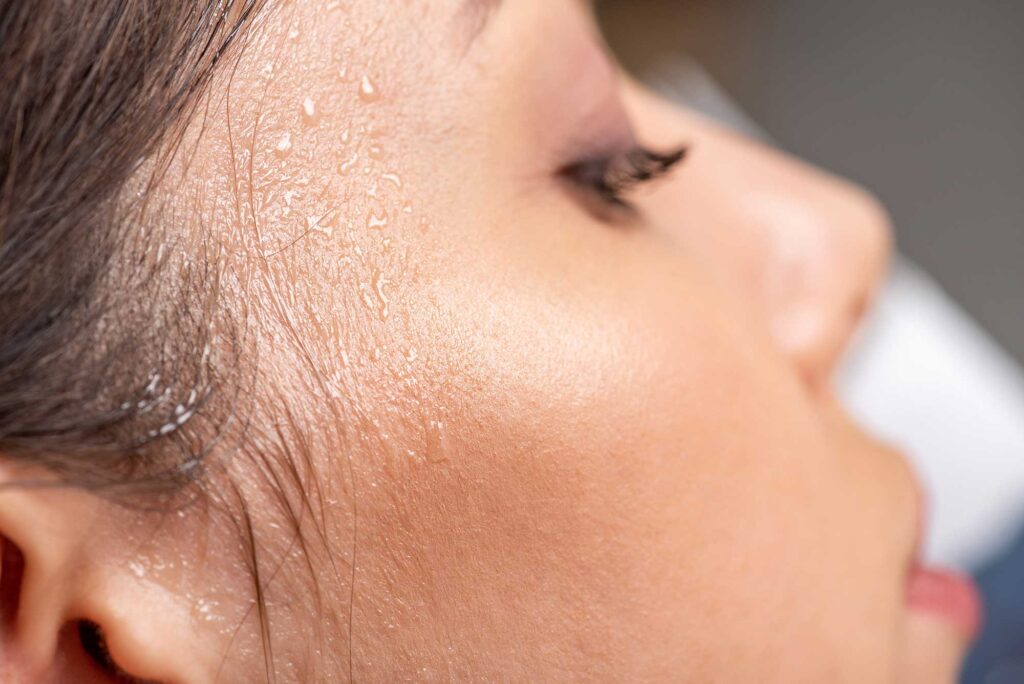 Close-up of child’s sweaty forehead and temple