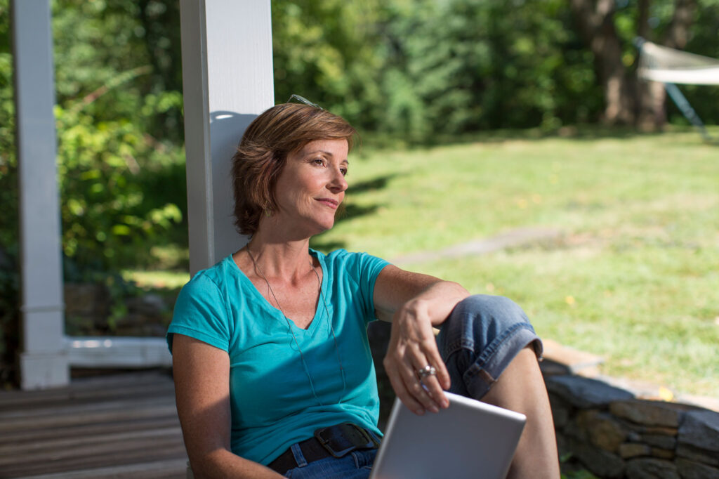 thoughtful woman relaxing outdoors with tablet 2026 03 25 08 28 00 utc