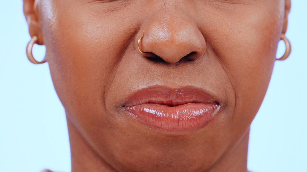 Close-up of woman's lips and nose ring