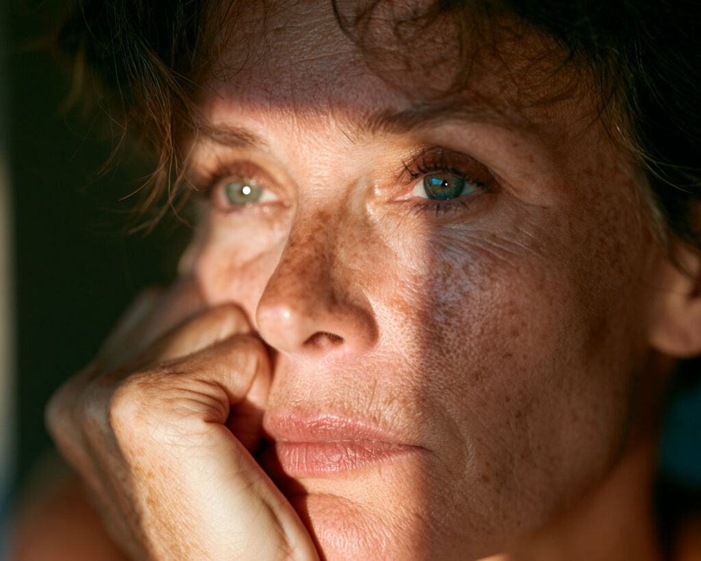 Close-up of woman resting chin on hand