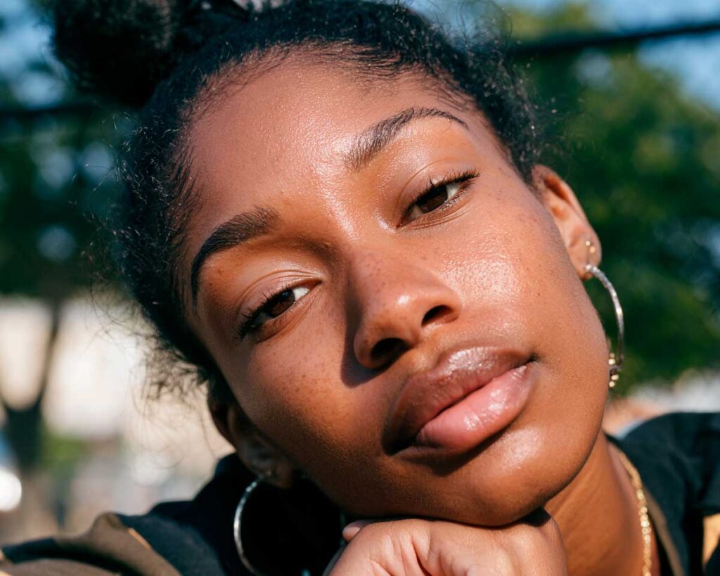 Close-up portrait of woman outdoors in sunlight