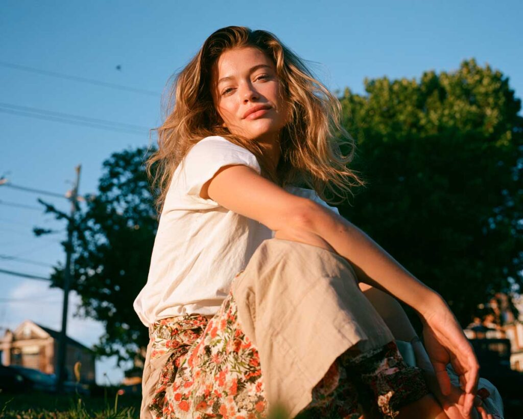 Woman sitting outdoors in golden sunset light