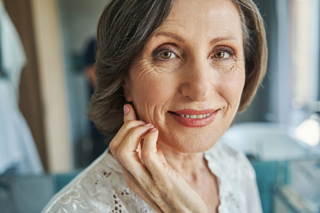 Close-up portrait of smiling middle-aged woman indoors
