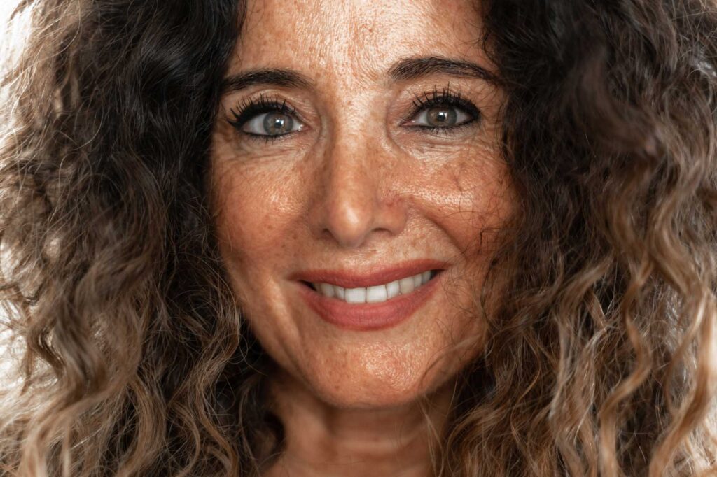 Close-up of smiling woman with curly hair
