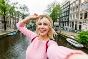 Woman taking selfie by scenic canal