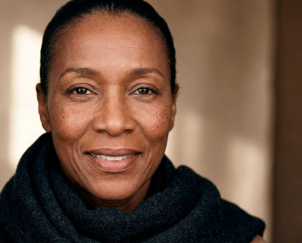 Close-up portrait of smiling woman in dark scarf