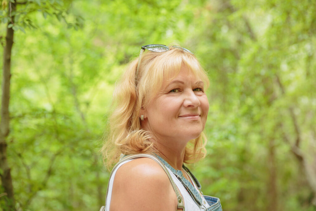 middle aged woman with backpack walking along fore 2026 03 24 02 22 58 utc