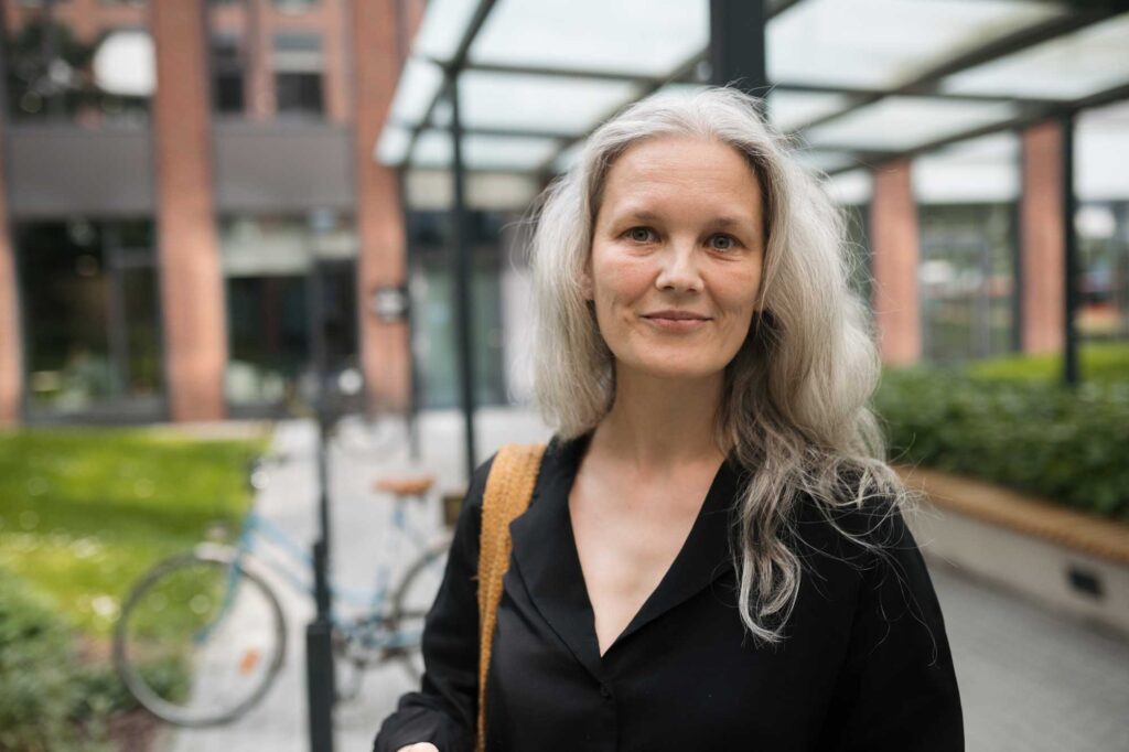Woman with gray hair outside modern building