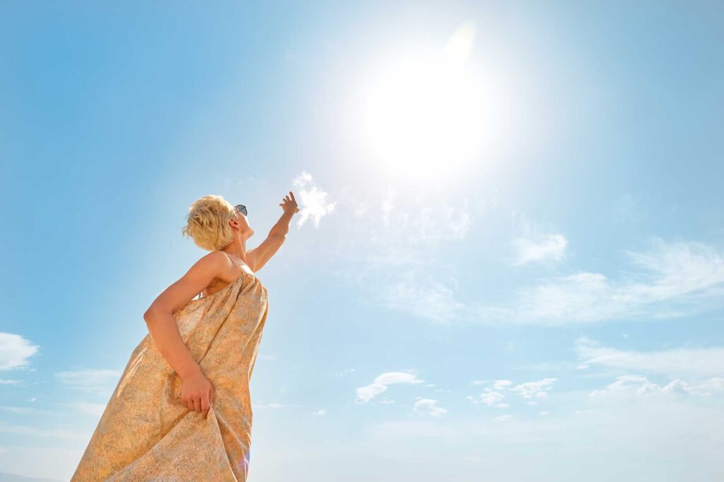 pretty blond woman reaches out to the sun enjoyin 2026 03 19 09 35 51 utc