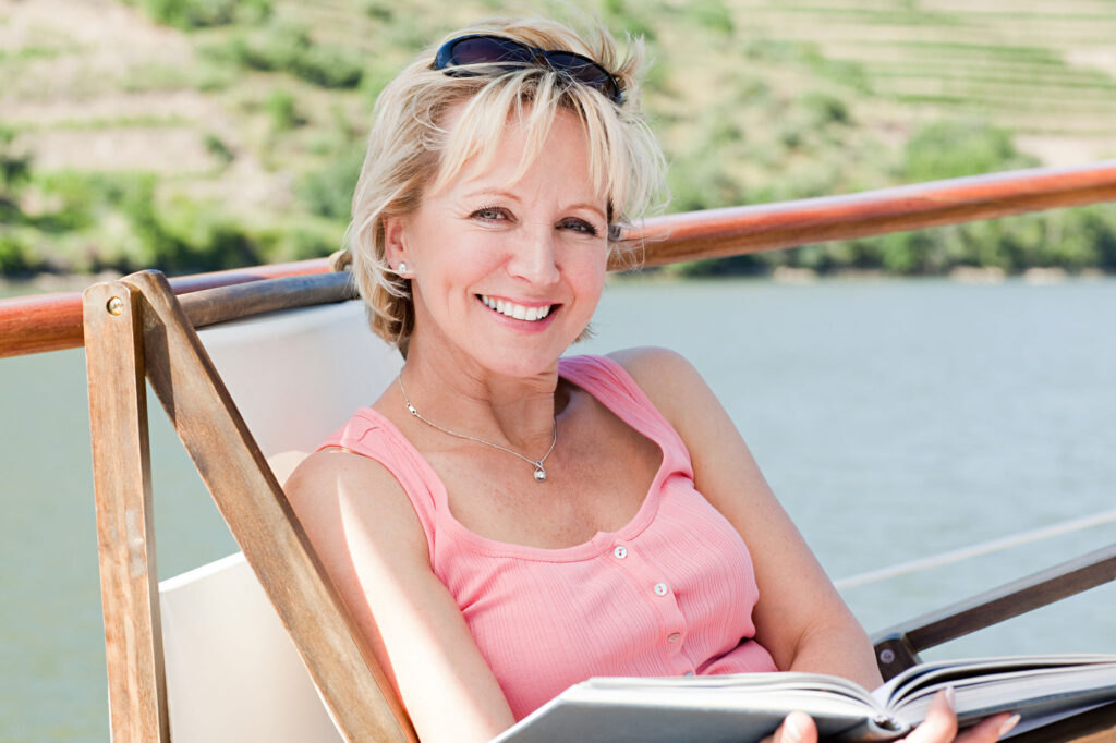 relaxing woman reads book outdoors on deck 2026 03 25 01 39 10 utc