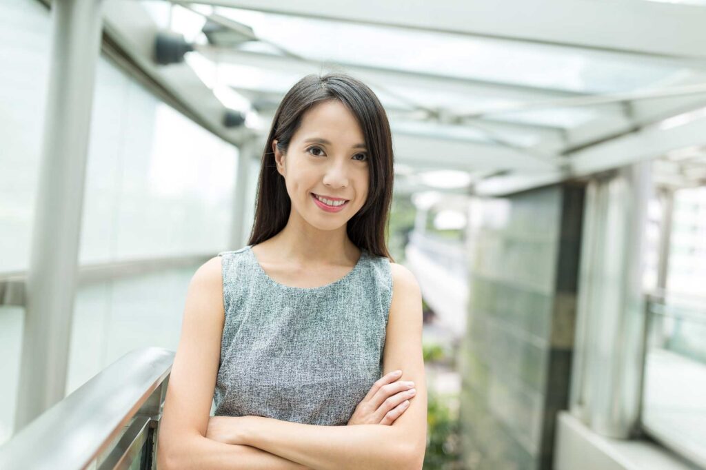 Smiling woman standing in modern outdoor walkway