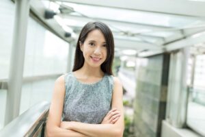Smiling woman standing in modern outdoor walkway