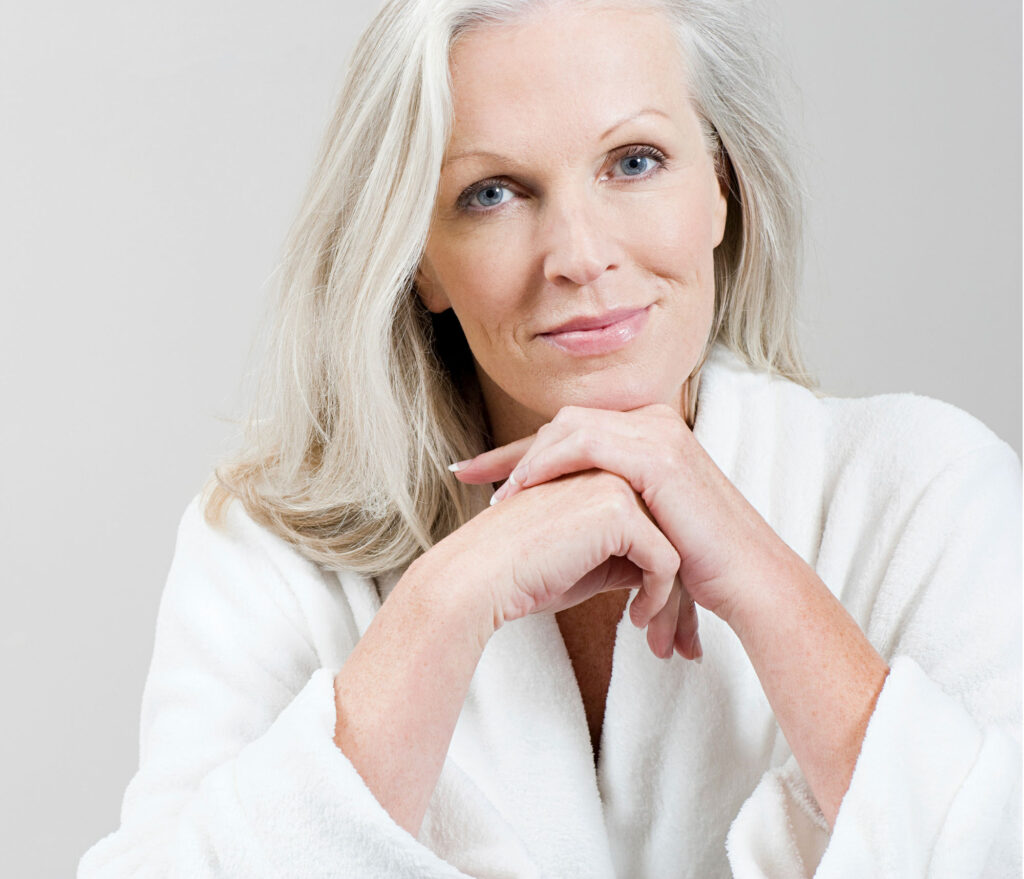 Close-up portrait of smiling gray-haired woman