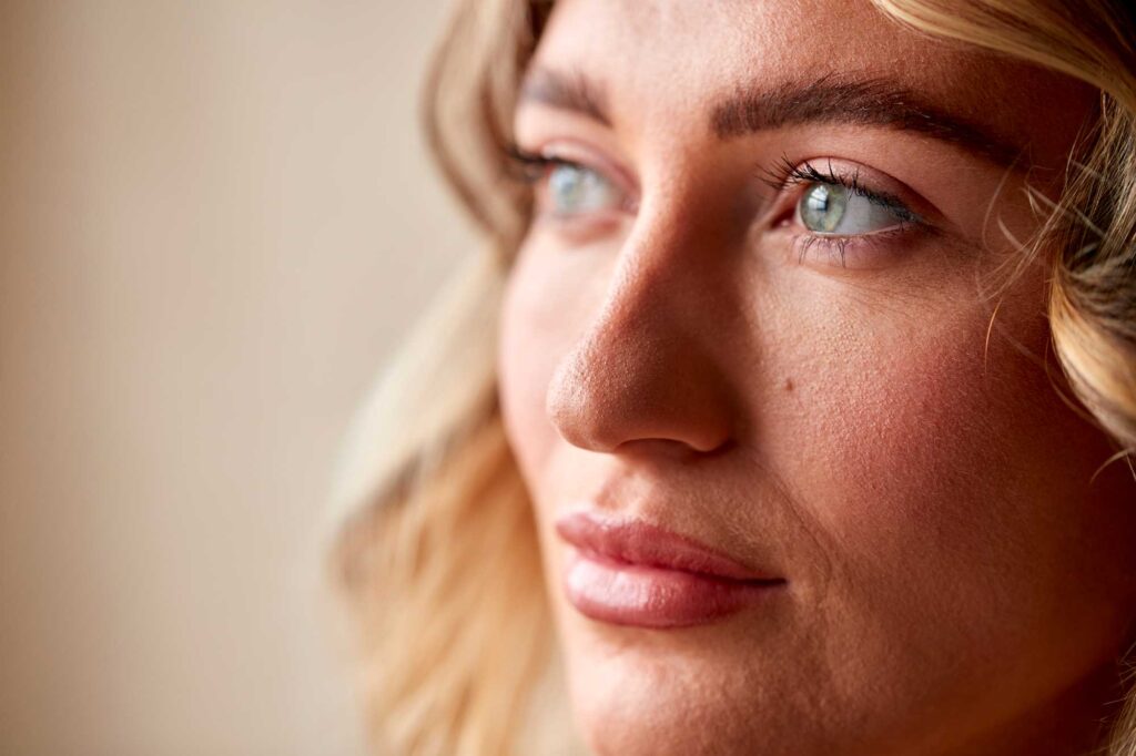 Close-up of woman gazing thoughtfully sideways