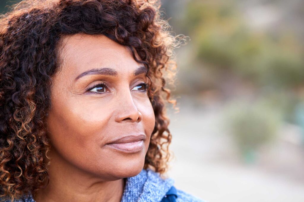 Close-up of woman with curly hair outdoors