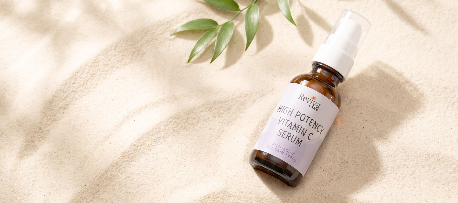 High-potency vitamin C serum bottle on sand